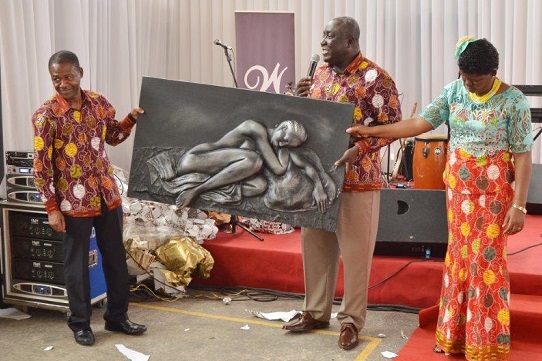 Mr Kwame Ofori-Gyau (middle), the Human Resource Director of Tex Styles Ghana, presenting a parting gift to Mr Boateng, on behalf of the company